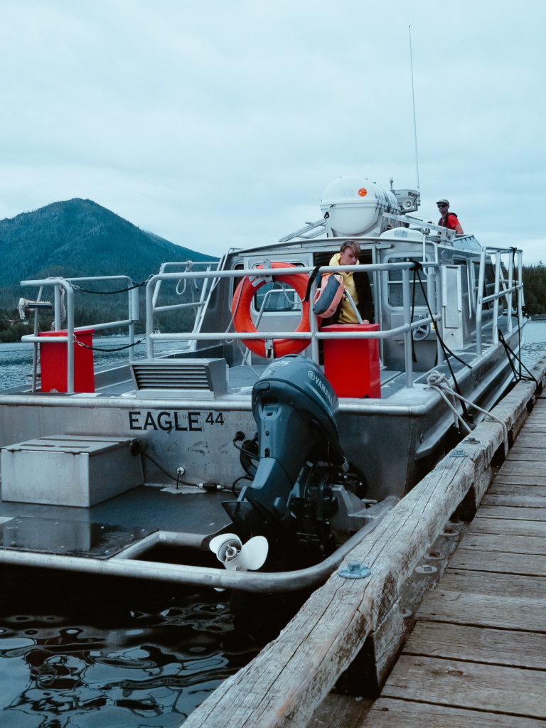 A boat named Eagle moored to a dock in Hot Springs Cove.