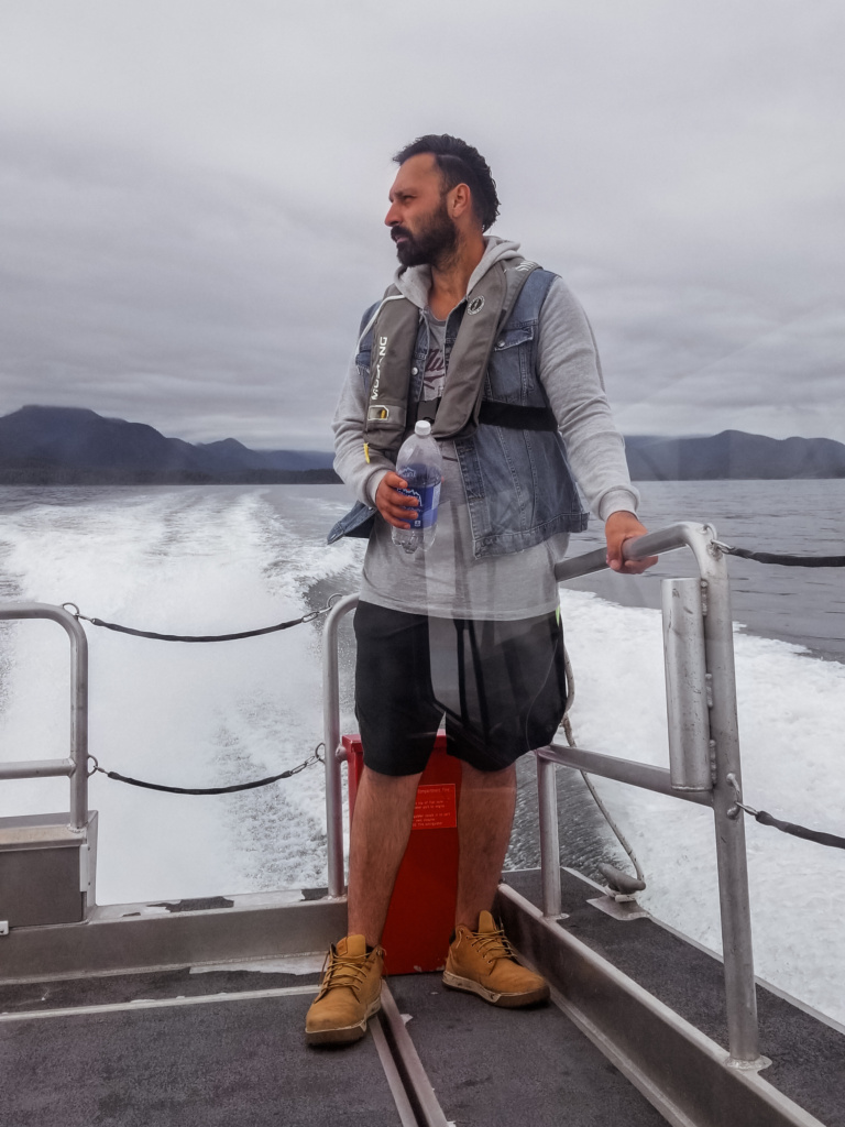 A man riding on a boat in the Pacific Ocean. 